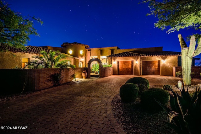 mediterranean / spanish home with a garage