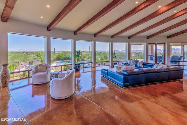 living room featuring lofted ceiling with beams and concrete floors