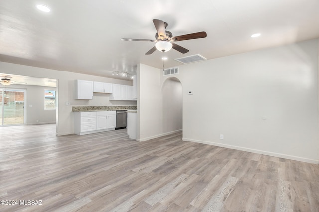 unfurnished living room featuring ceiling fan and light hardwood / wood-style floors