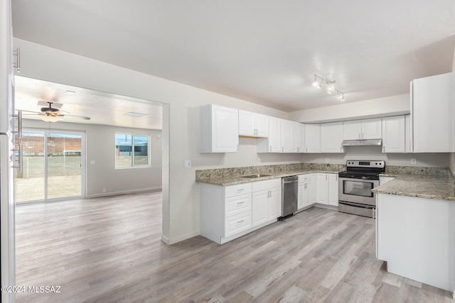 kitchen with light wood-type flooring, ceiling fan, stainless steel appliances, and white cabinets