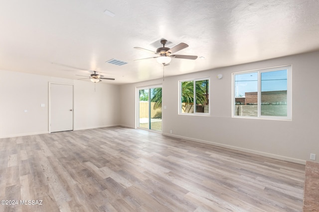 unfurnished room with ceiling fan and light hardwood / wood-style floors