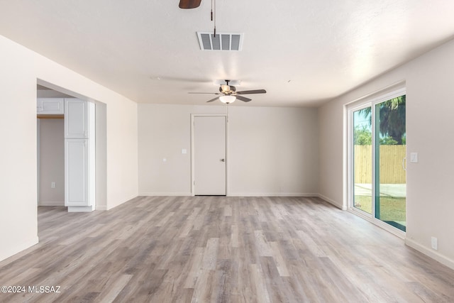 spare room featuring ceiling fan and light hardwood / wood-style flooring