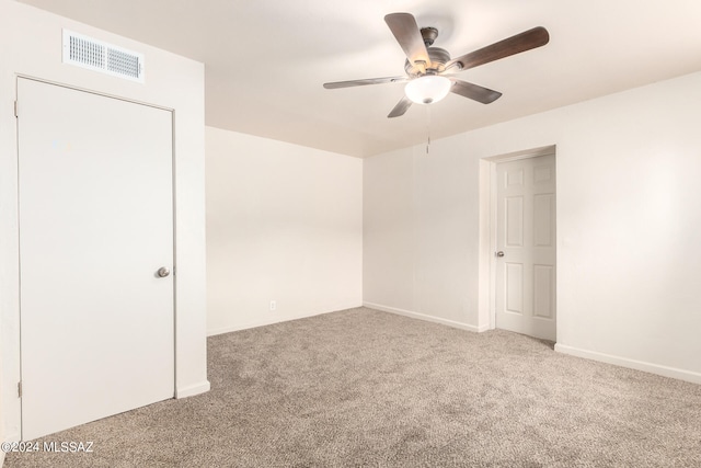 spare room featuring carpet flooring and ceiling fan