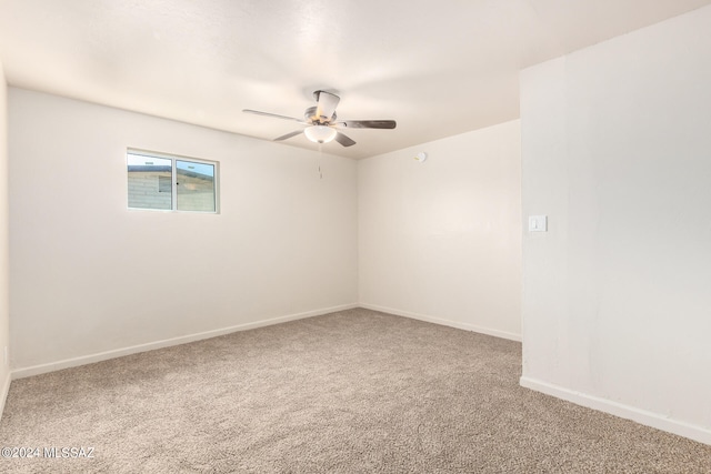 empty room with ceiling fan and carpet floors