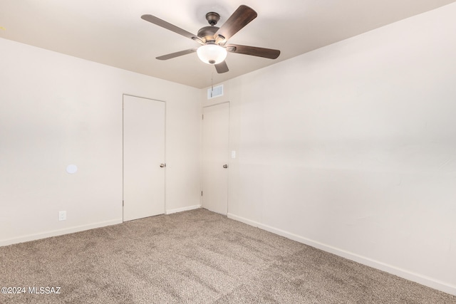 empty room featuring carpet floors and ceiling fan