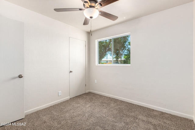 empty room featuring ceiling fan and carpet flooring