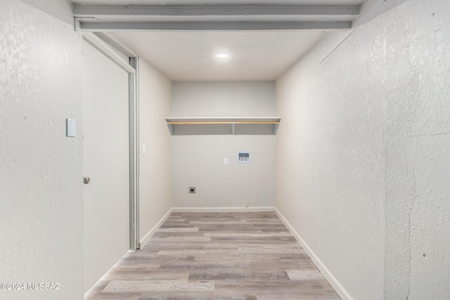 washroom featuring light hardwood / wood-style floors, electric dryer hookup, and hookup for a washing machine