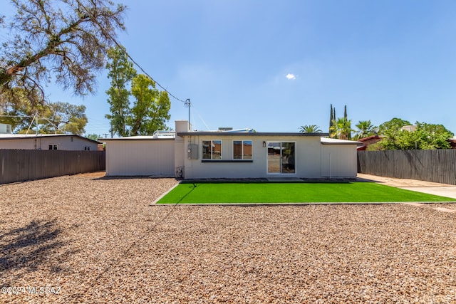 rear view of house with a lawn