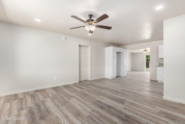 unfurnished living room featuring light hardwood / wood-style flooring and ceiling fan