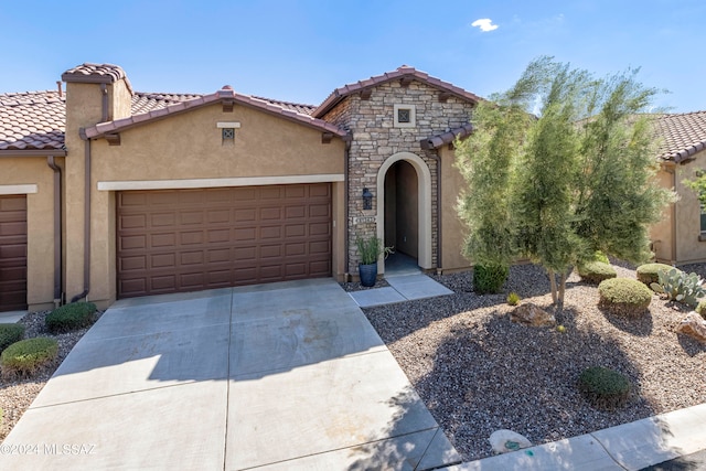 mediterranean / spanish-style house with a garage