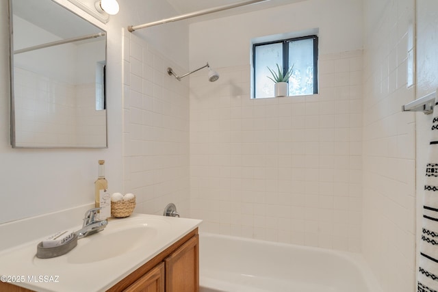 bathroom featuring vanity and tiled shower / bath combo