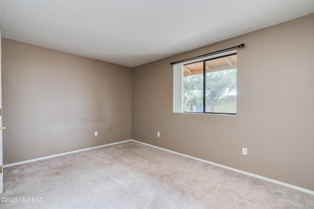 empty room featuring light carpet