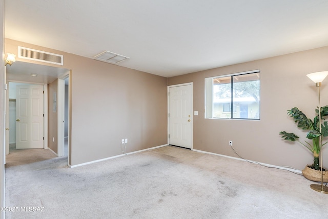 unfurnished room featuring light carpet