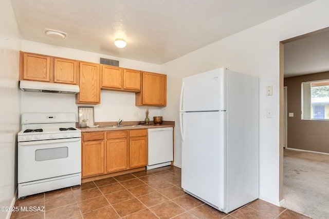 kitchen featuring dark colored carpet, white appliances, and sink