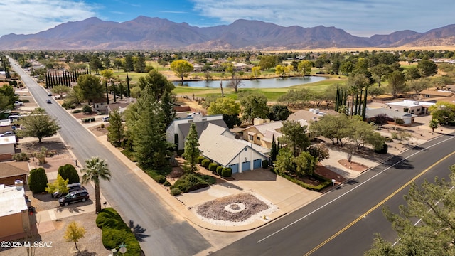 drone / aerial view with a water and mountain view