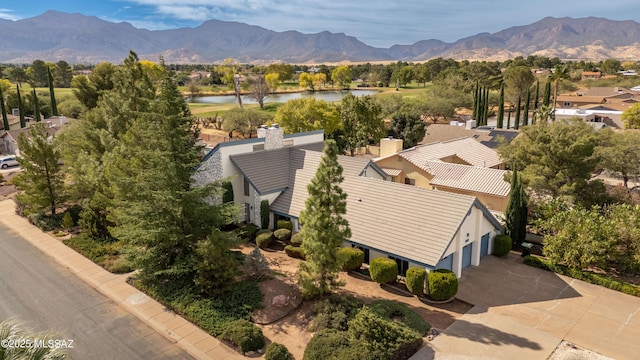 birds eye view of property featuring a water and mountain view