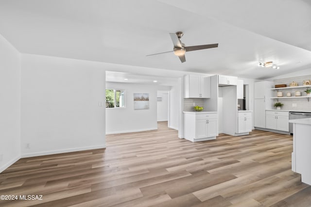 kitchen featuring decorative backsplash, white cabinets, and dishwasher