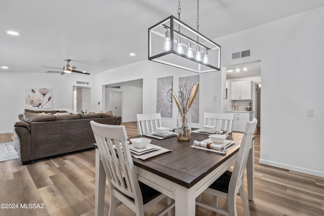 dining space with ceiling fan and light hardwood / wood-style flooring