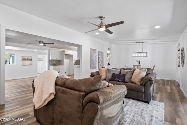 living room with hardwood / wood-style floors and ceiling fan