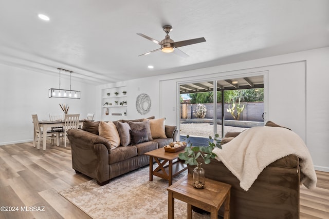 living room featuring light hardwood / wood-style floors and ceiling fan