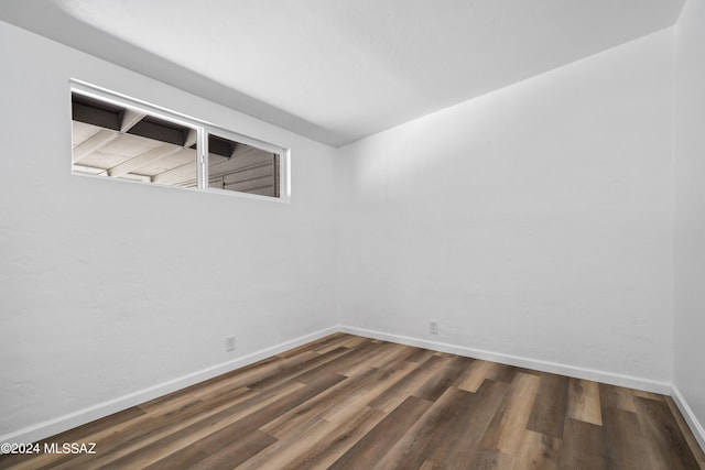 empty room featuring dark wood-type flooring