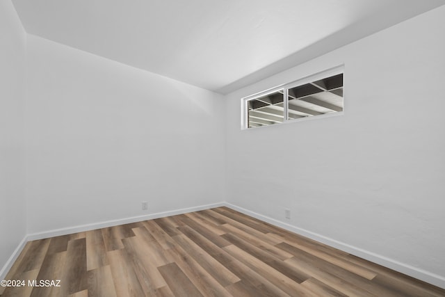 unfurnished room with hardwood / wood-style flooring