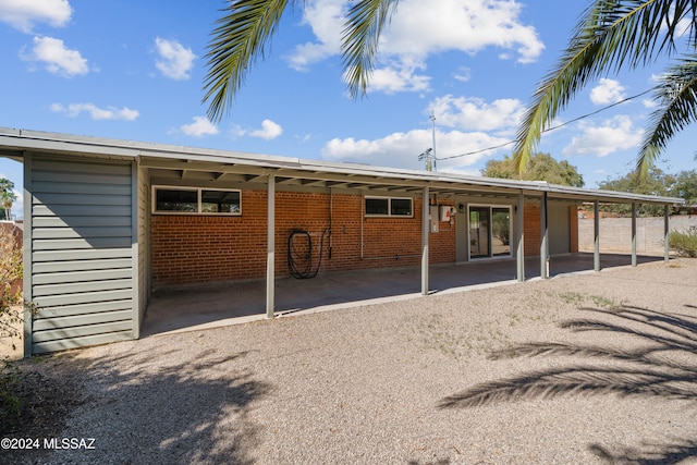 rear view of property featuring a carport