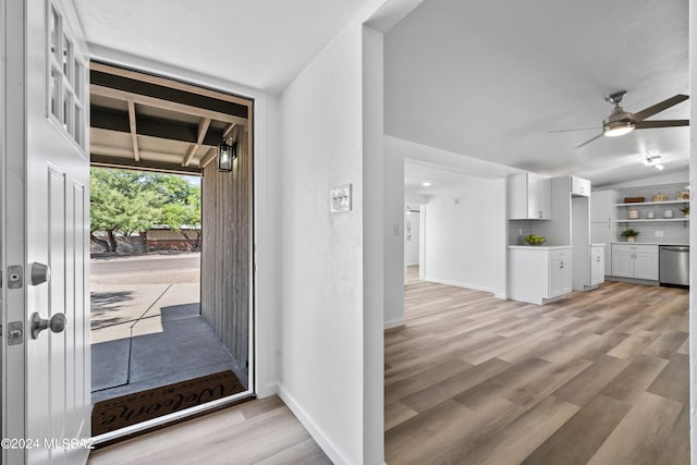 foyer featuring ceiling fan, lofted ceiling with beams, and light wood-type flooring