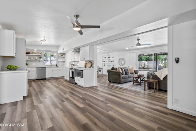 kitchen featuring white cabinetry, stainless steel appliances, wood-type flooring, and plenty of natural light