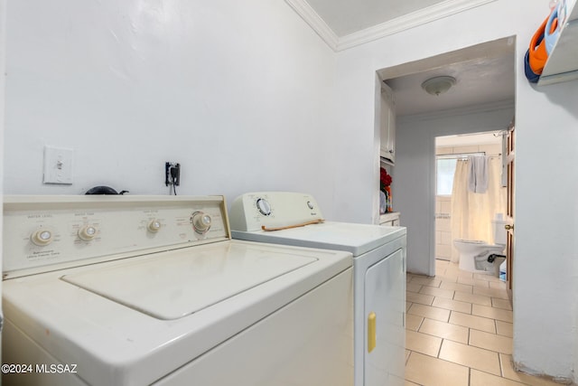 washroom with separate washer and dryer, light tile patterned flooring, and ornamental molding