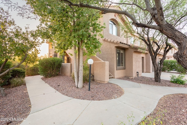 view of side of property featuring stucco siding
