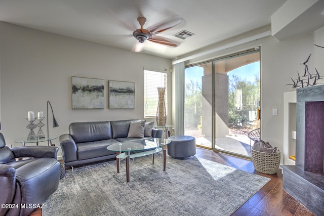 living room featuring dark hardwood / wood-style flooring and ceiling fan