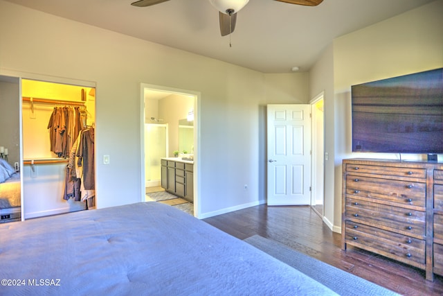 bedroom with hardwood / wood-style flooring, ceiling fan, a spacious closet, connected bathroom, and a closet