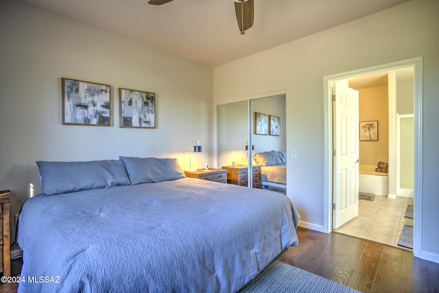 bedroom featuring a closet, hardwood / wood-style flooring, ceiling fan, and ensuite bathroom