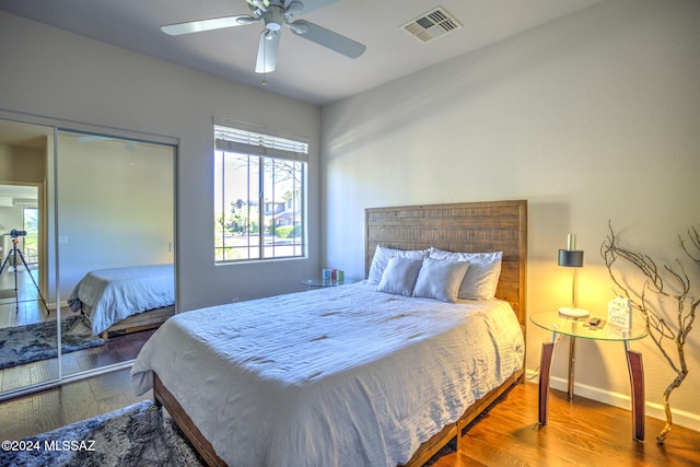 bedroom featuring a closet, wood-type flooring, and ceiling fan