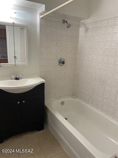 bathroom with bathtub / shower combination, tile patterned floors, and vanity