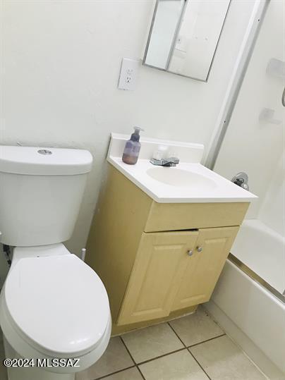 full bathroom featuring tile patterned flooring,  shower combination, vanity, and toilet