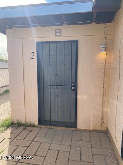 view of exterior entry with fence