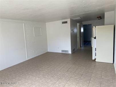 unfurnished room featuring visible vents