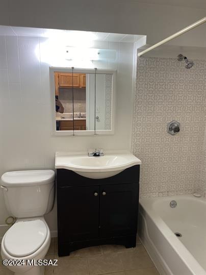 full bathroom with washtub / shower combination, tile patterned flooring, vanity, and toilet