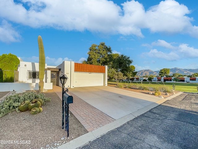 view of front of home with a garage and a mountain view