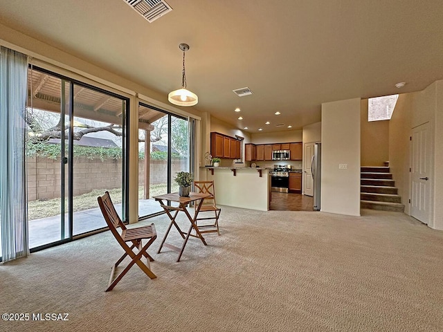 unfurnished dining area featuring light colored carpet