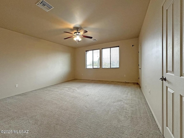 empty room featuring light carpet and ceiling fan