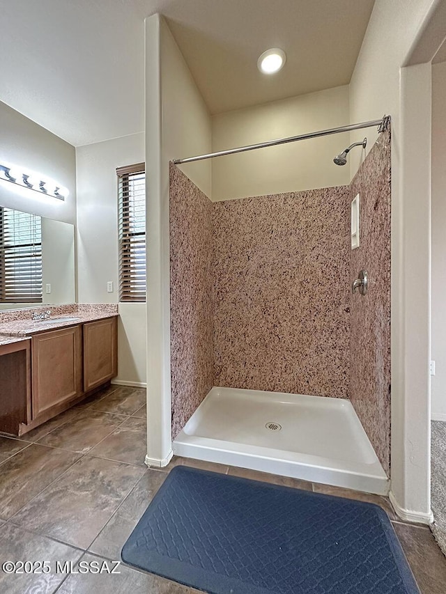 bathroom featuring vanity and tiled shower