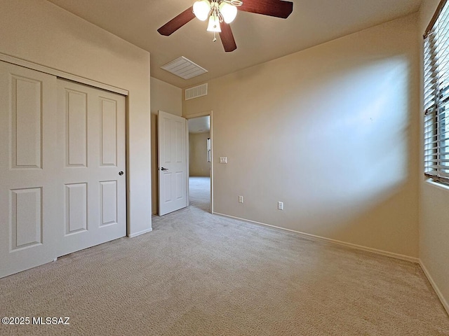 unfurnished bedroom with multiple windows, ceiling fan, a closet, and light colored carpet