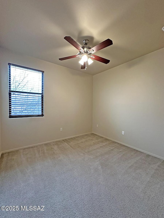 carpeted spare room with ceiling fan