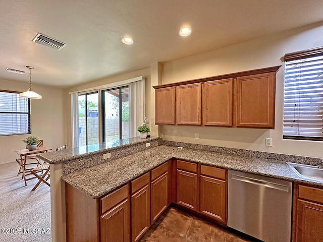 kitchen featuring kitchen peninsula, stainless steel dishwasher, dark carpet, sink, and pendant lighting