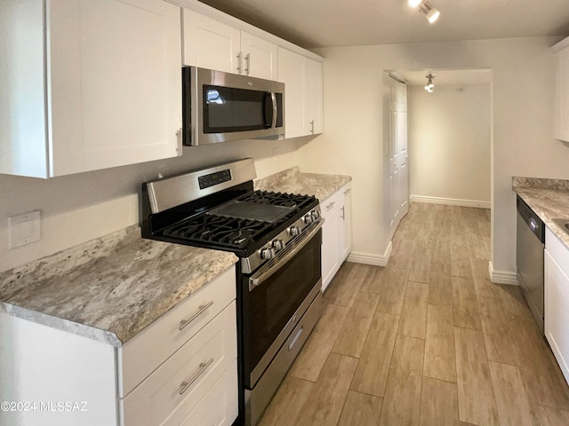 kitchen featuring light hardwood / wood-style flooring, appliances with stainless steel finishes, and white cabinetry