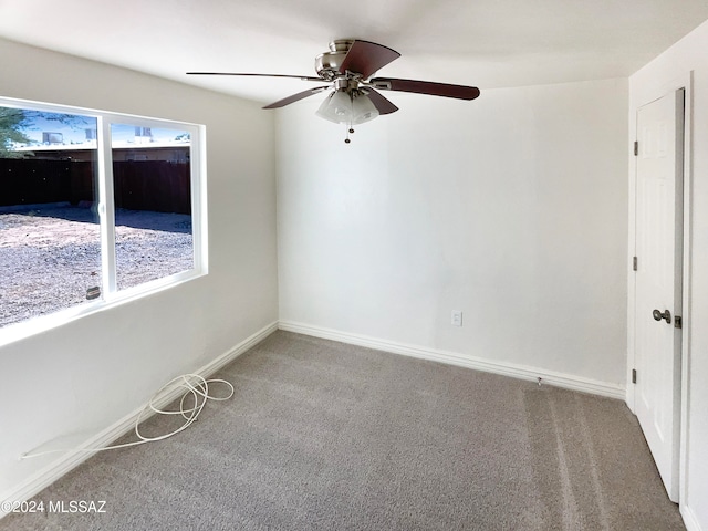 unfurnished room featuring ceiling fan and carpet floors