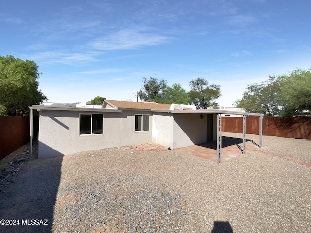 back of property with a patio